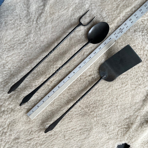 set of cooking utensils for cooking over the fire.